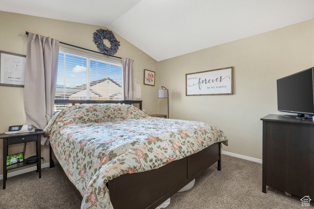 Bedroom featuring carpet floors and lofted ceiling