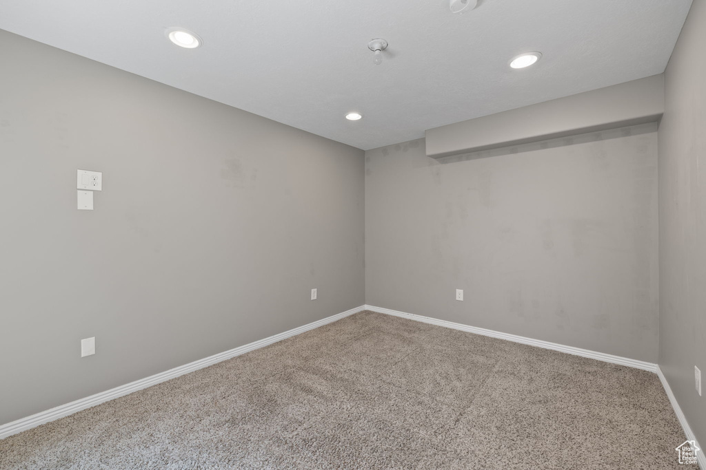 Empty room with carpet and recessed lighting