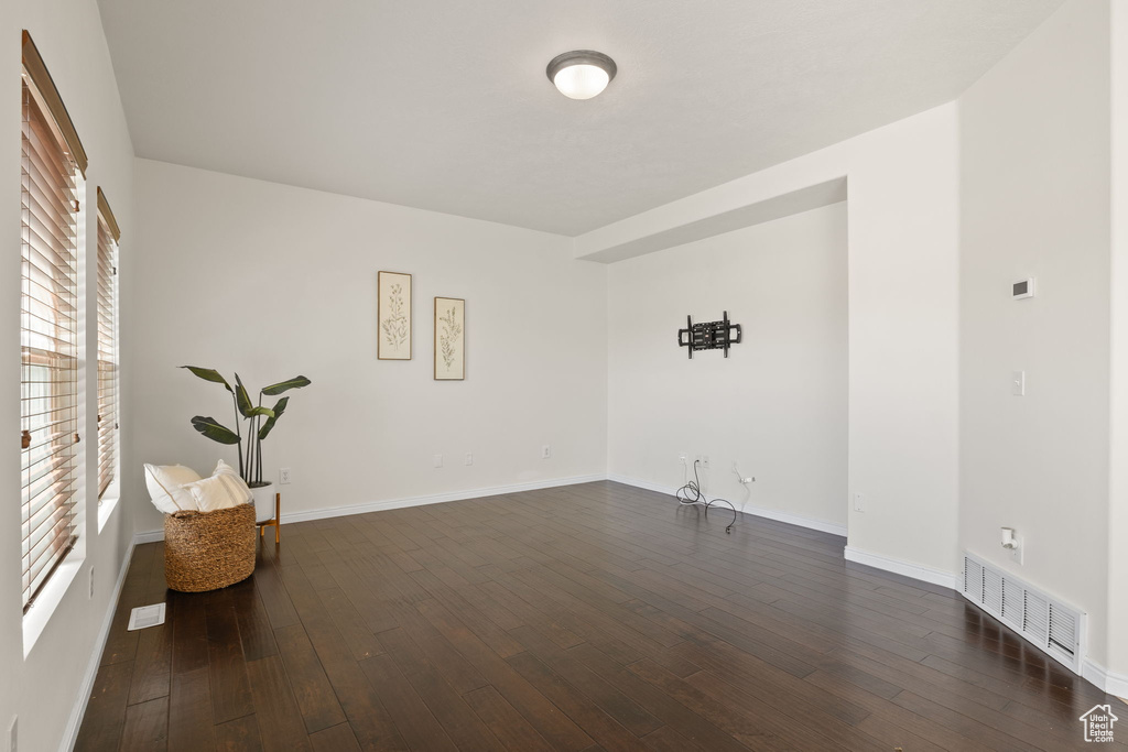 Spare room with dark wood-style flooring