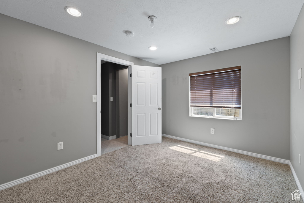 Unfurnished bedroom featuring carpet floors and recessed lighting