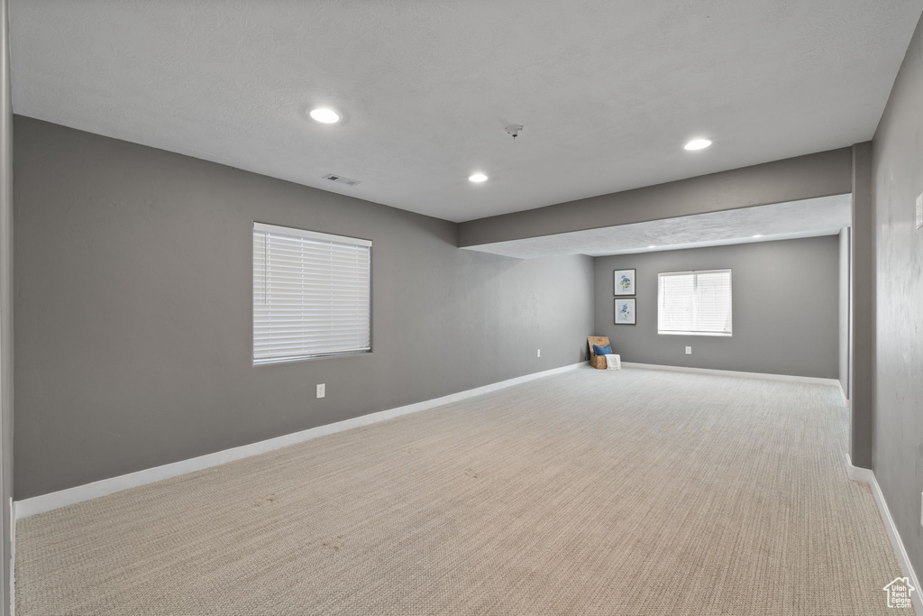 Basement with recessed lighting and carpet