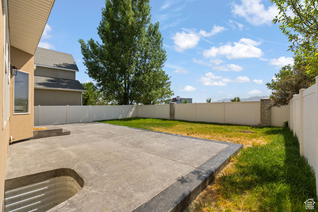 Fenced backyard with a patio area