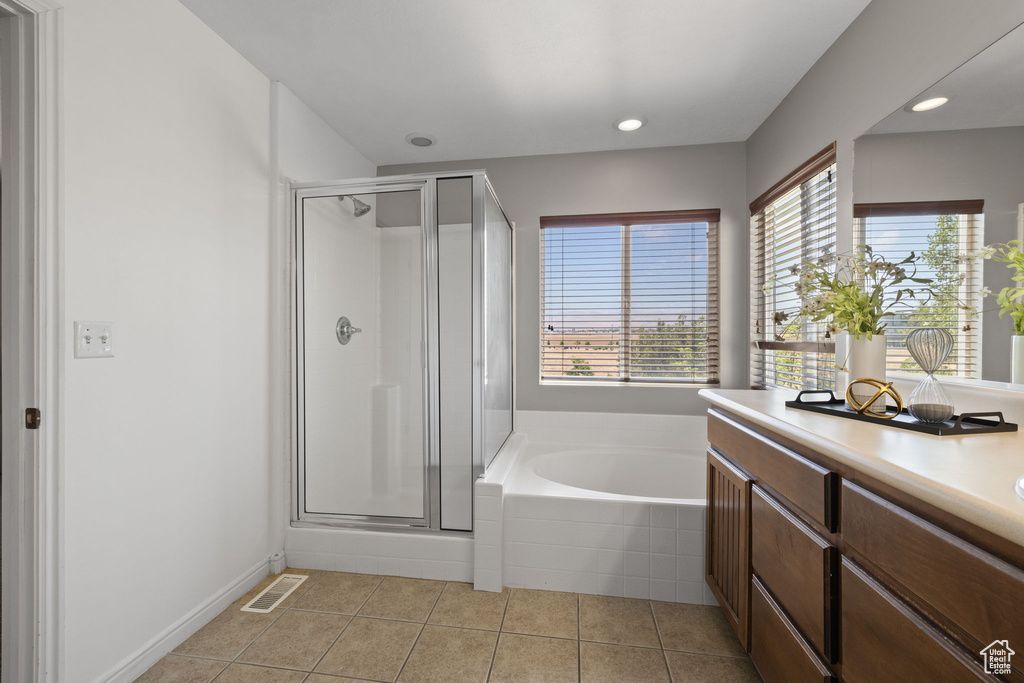 Bathroom featuring a shower stall, a bath, vanity, tile patterned flooring, and recessed lighting