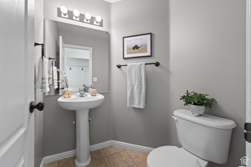 Bathroom featuring toilet and tile patterned floors