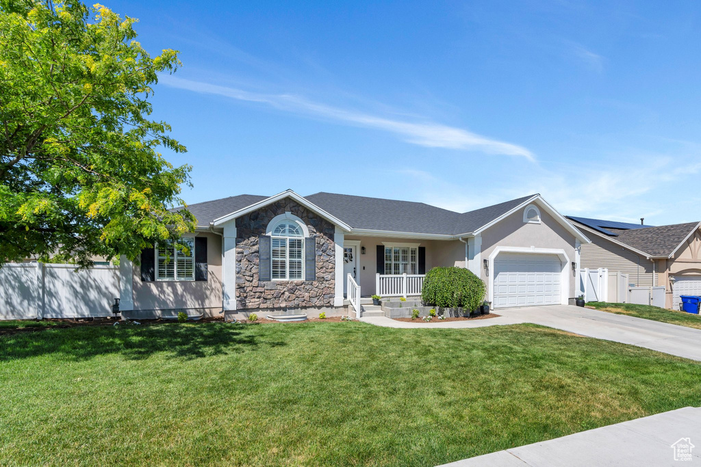 Ranch-style house featuring driveway, covered porch, a garage, stone siding, and stucco siding