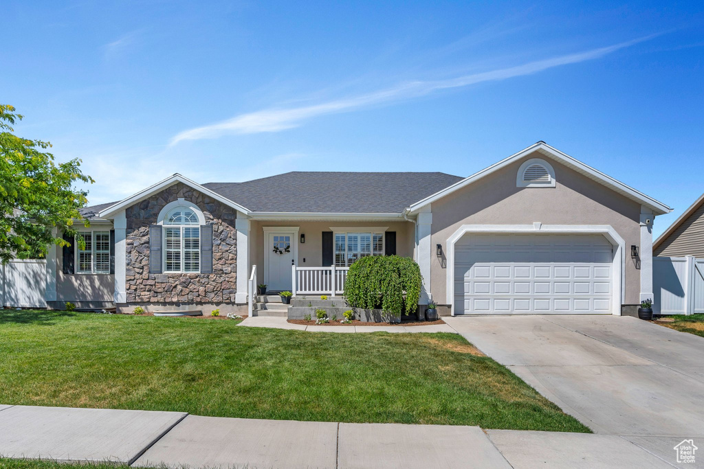 Single story home with an attached garage, concrete driveway, a porch, stucco siding, and stone siding