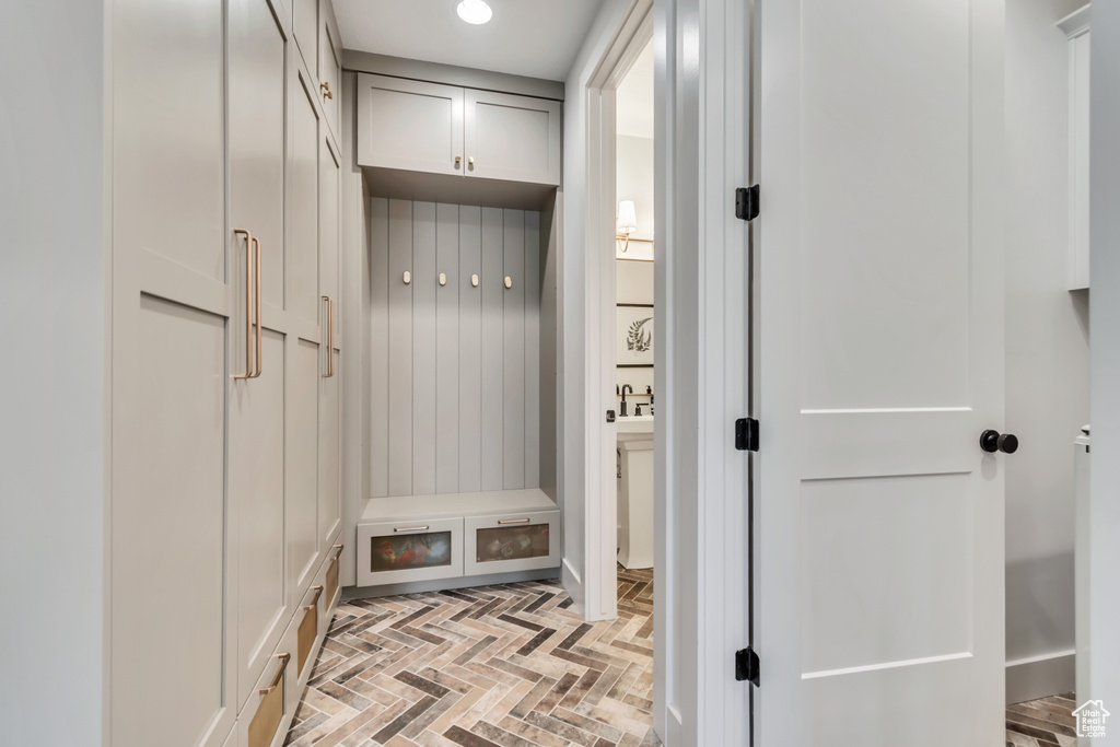 Mudroom with brick floors and recessed lighting