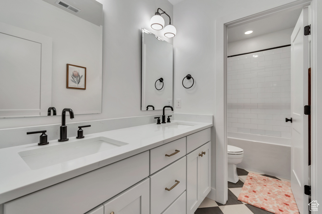 Full bathroom with double vanity, washtub / shower combination, and recessed lighting