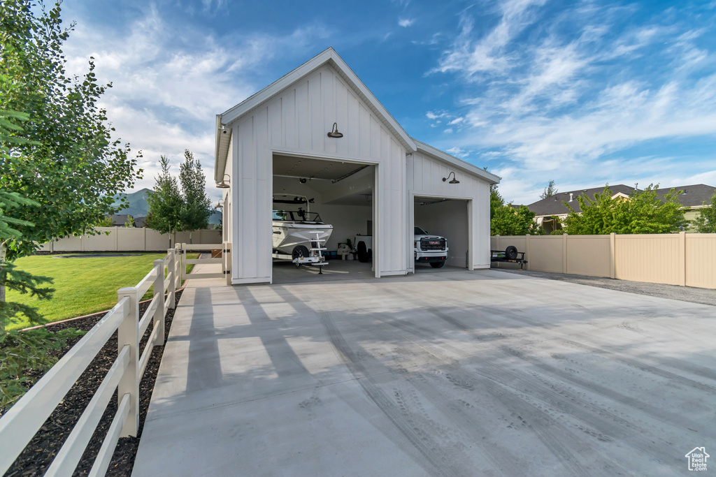 View of patio / terrace featuring an outdoor structure and a garage