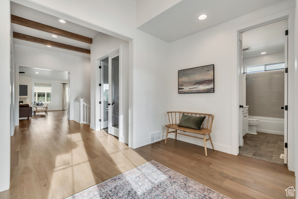 Hallway with wood finished floors and recessed lighting