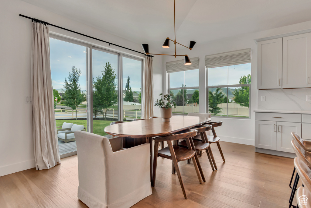 Dining space with baseboards and light wood-style flooring