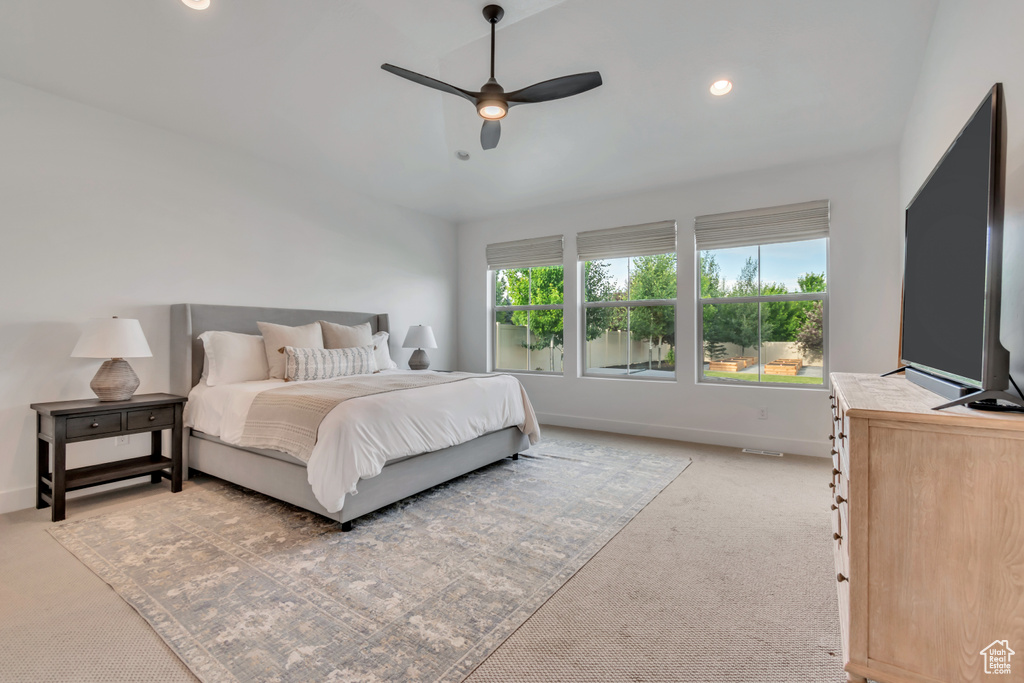 Bedroom with light carpet, recessed lighting, ceiling fan, and lofted ceiling