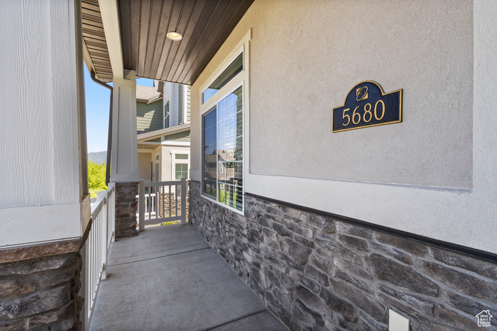View of exterior entry featuring stone siding and stucco siding