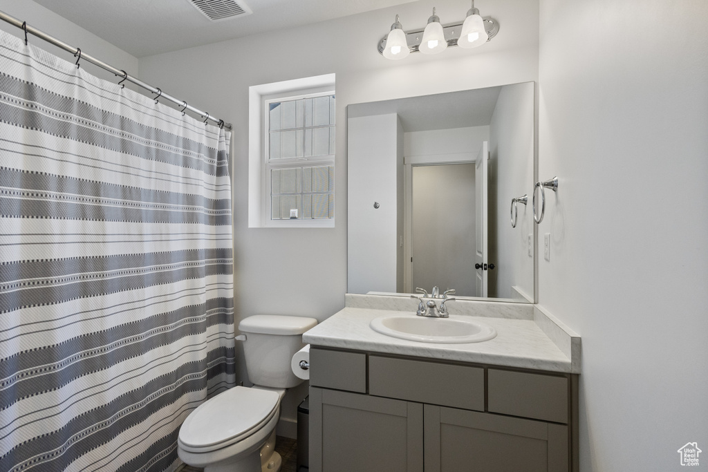 Bathroom featuring vanity and a shower with shower curtain