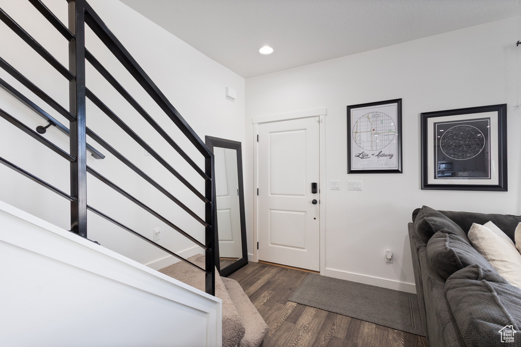 Entryway with stairway, dark wood-style floors, and recessed lighting