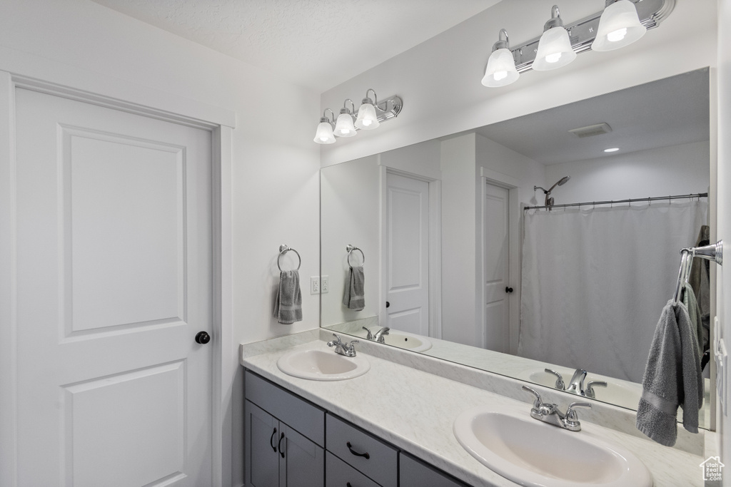 Full bath featuring double vanity