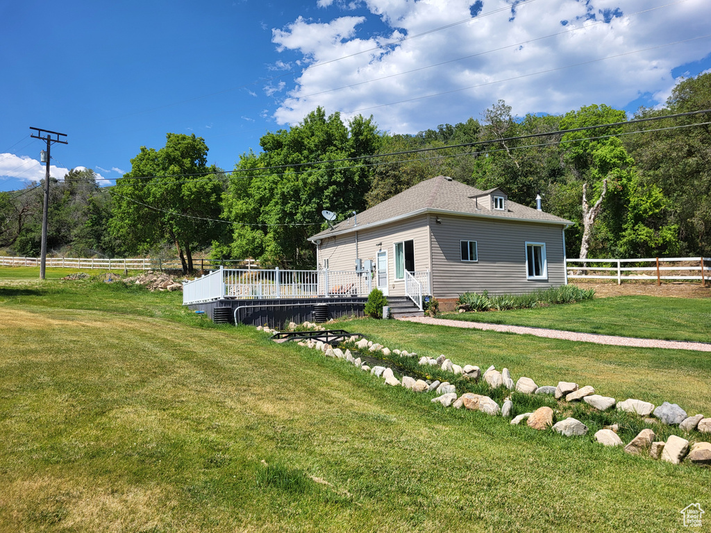 Back of house featuring a deck