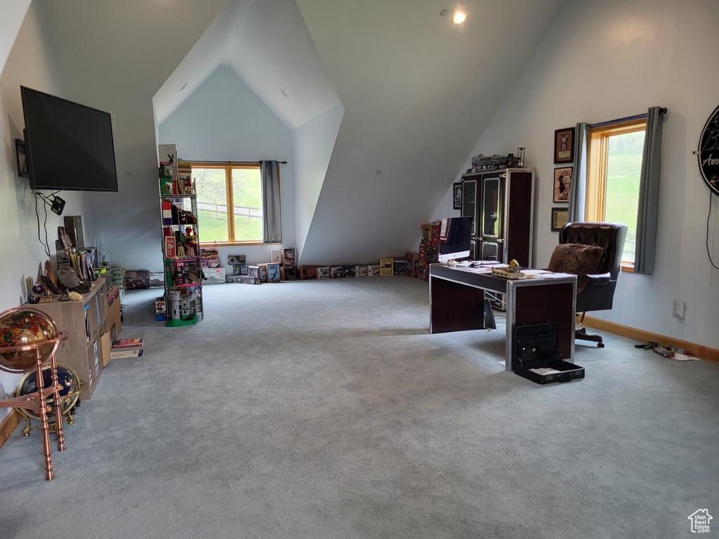 Carpeted home office with vaulted ceiling