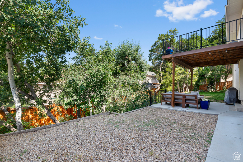 Fenced backyard featuring a patio area, outdoor lounge area, and a wooden deck