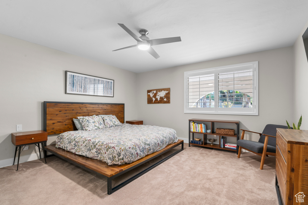 Bedroom featuring light colored carpet and a ceiling fan