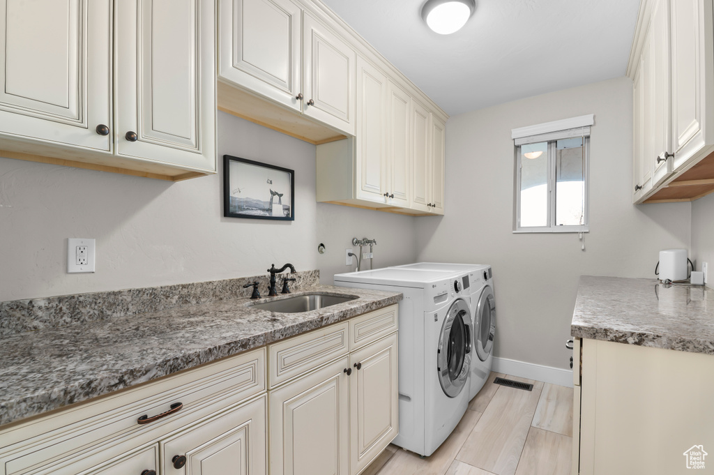 Laundry area featuring cabinet space and washer and dryer
