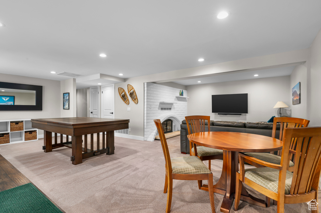 Dining space with recessed lighting and a brick fireplace