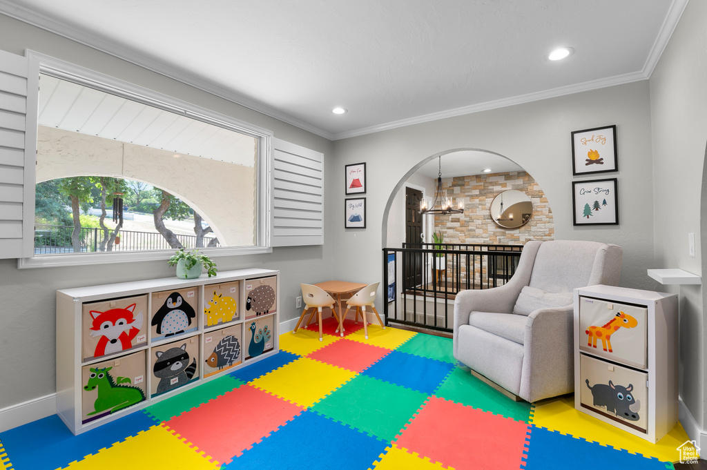 Game room featuring crown molding, recessed lighting, and arched walkways