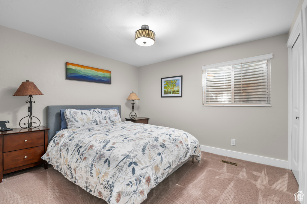 Bedroom with carpet and a closet