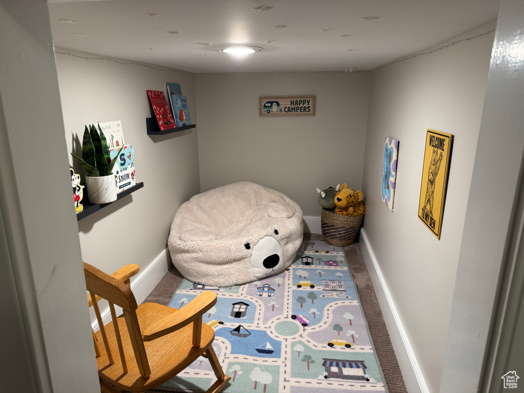 Living area featuring carpet and baseboards