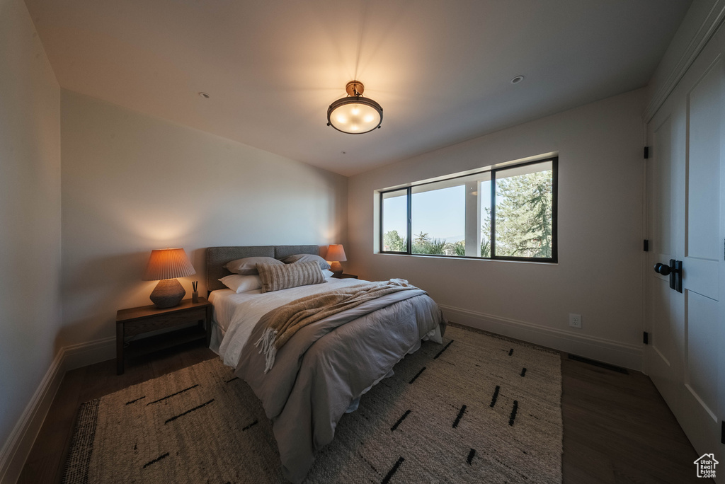 Bedroom featuring baseboards and wood finished floors