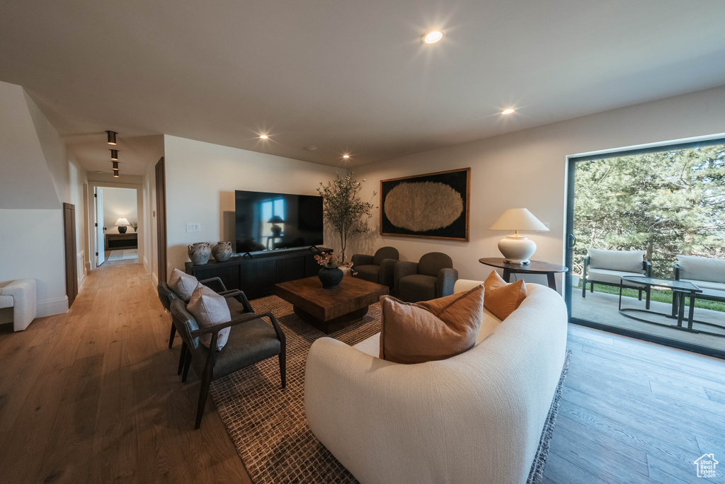Living area with wood finished floors and recessed lighting