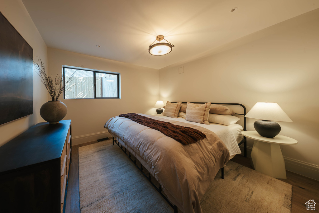 Bedroom with baseboards and wood finished floors