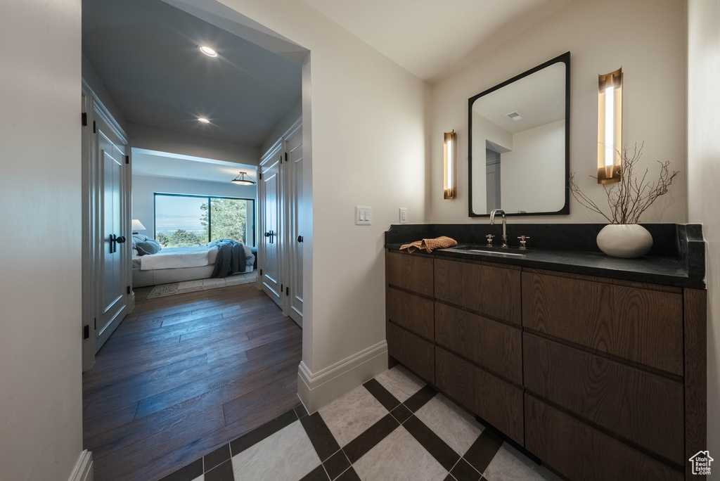 Bathroom featuring ensuite bathroom, vanity, recessed lighting, and wood finished floors