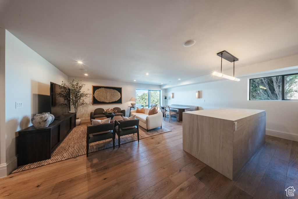 Living room featuring dark wood-style flooring and recessed lighting