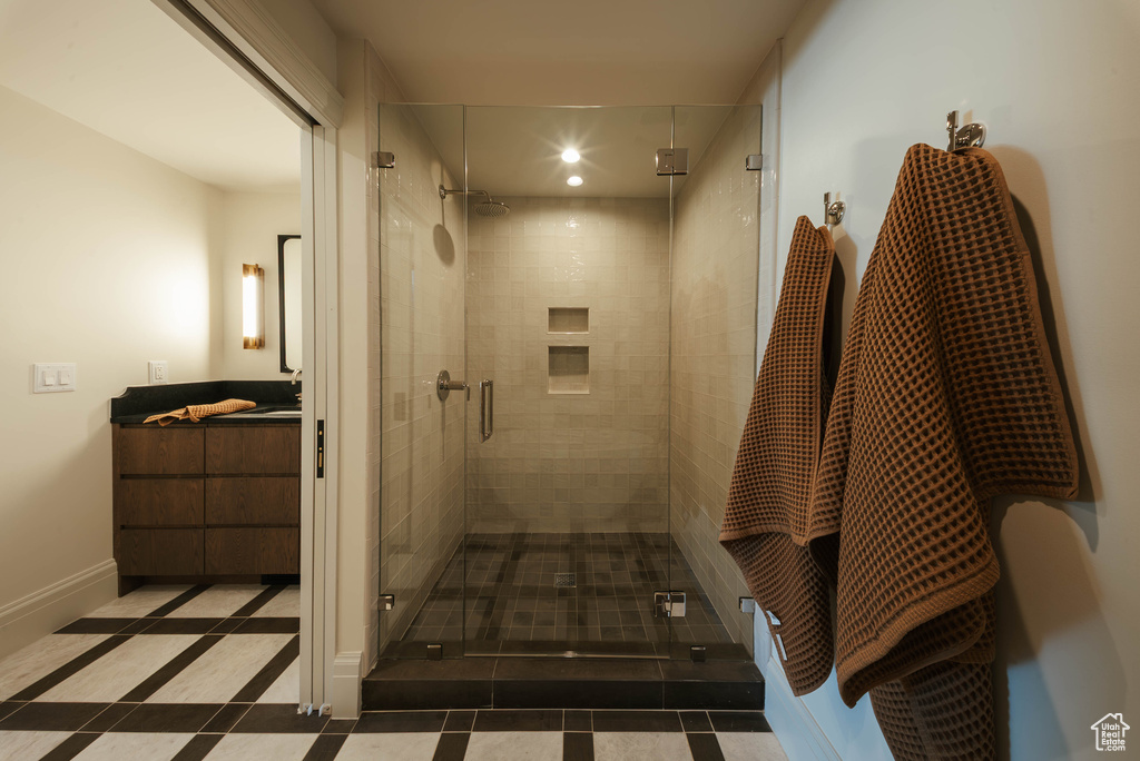 Full bath with a stall shower, vanity, tile patterned flooring, recessed lighting, and inlaid floor details
