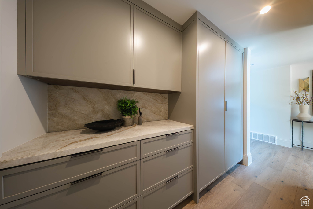 Detailed view of wood finished floors and decorative backsplash