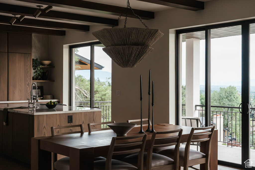 Dining area with beamed ceiling