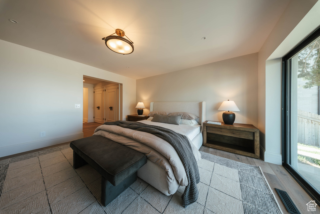 Bedroom featuring multiple windows and wood finished floors