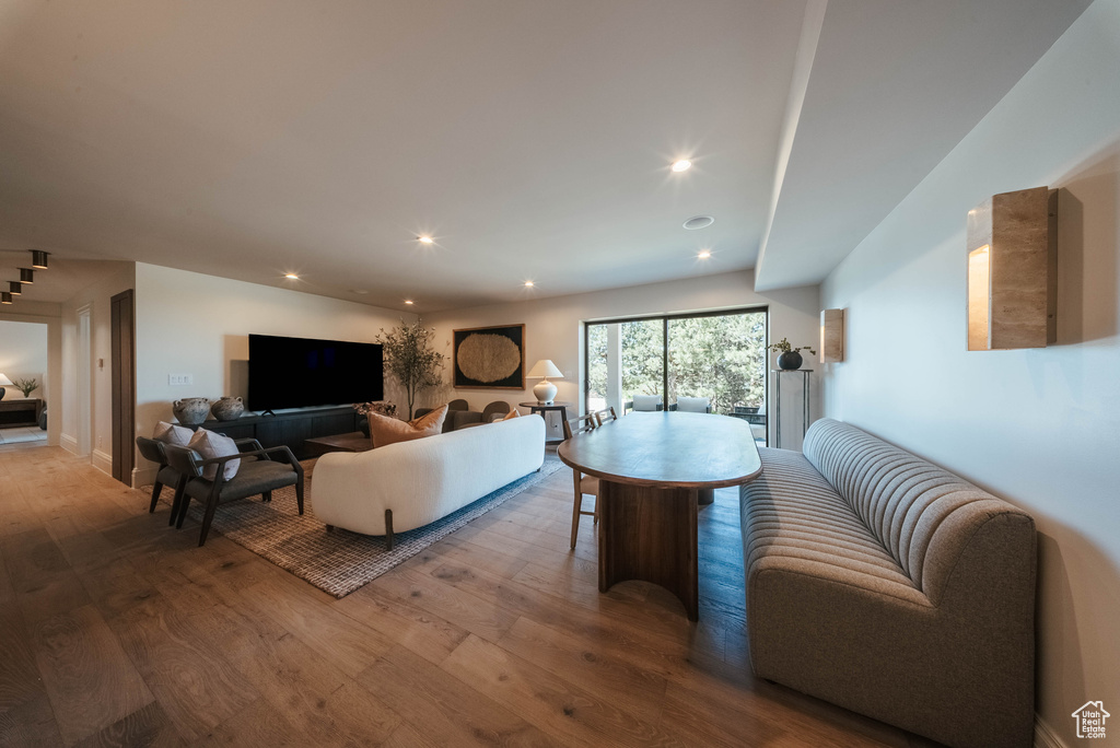 Living area with wood finished floors and recessed lighting