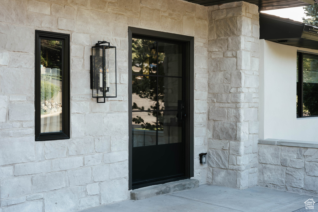 View of exterior entry featuring stone siding