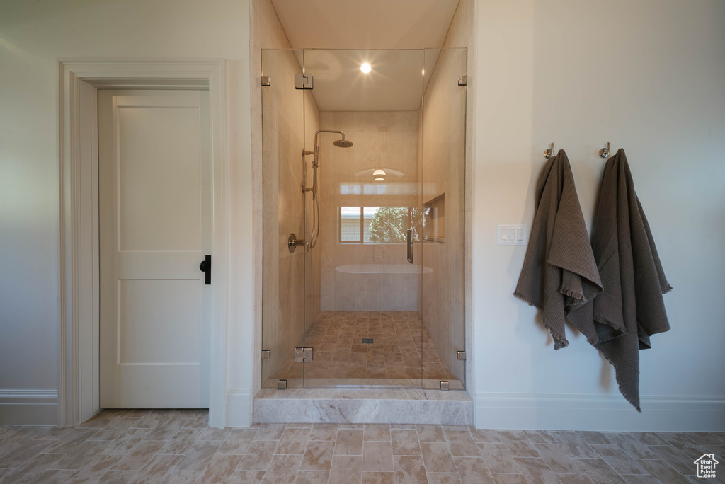 Bathroom with a stall shower and baseboards