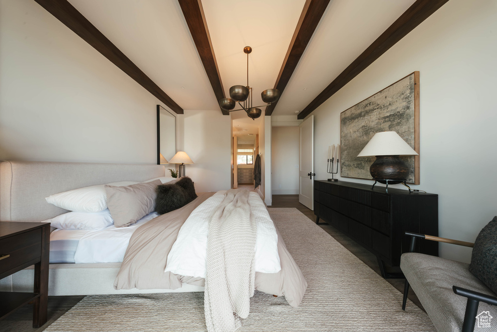 Bedroom with beamed ceiling and a chandelier