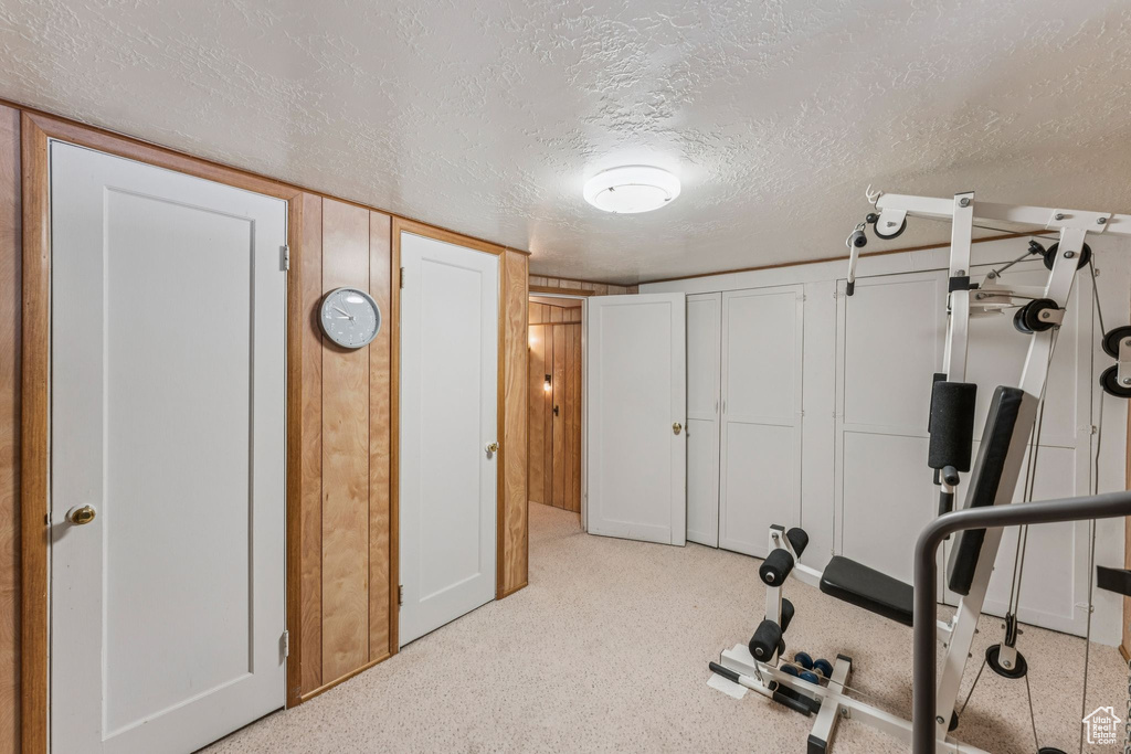 Exercise area featuring a textured ceiling