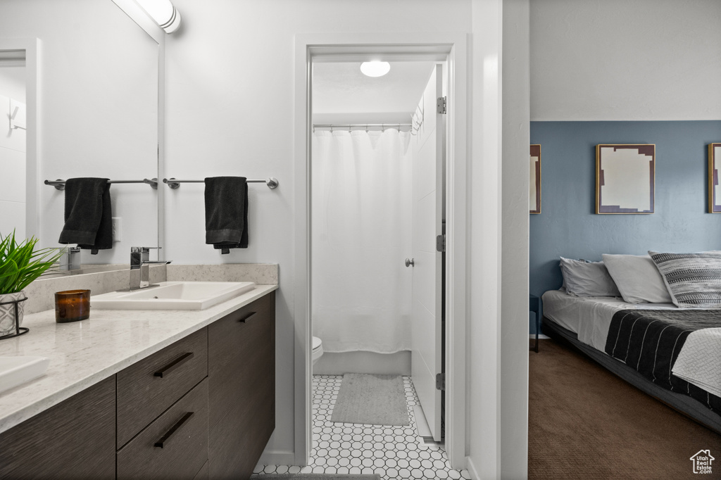 Full bathroom with double vanity, connected bathroom, and a shower with shower curtain