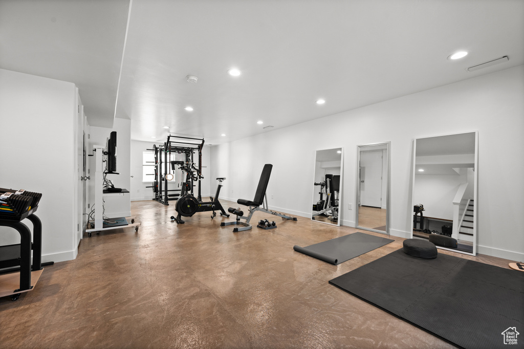 Exercise room with recessed lighting and baseboards