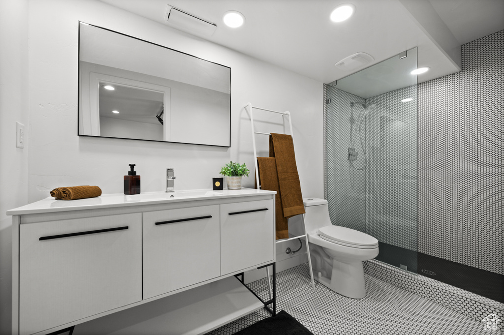 Full bath featuring vanity, walk in shower, recessed lighting, and tile patterned floors