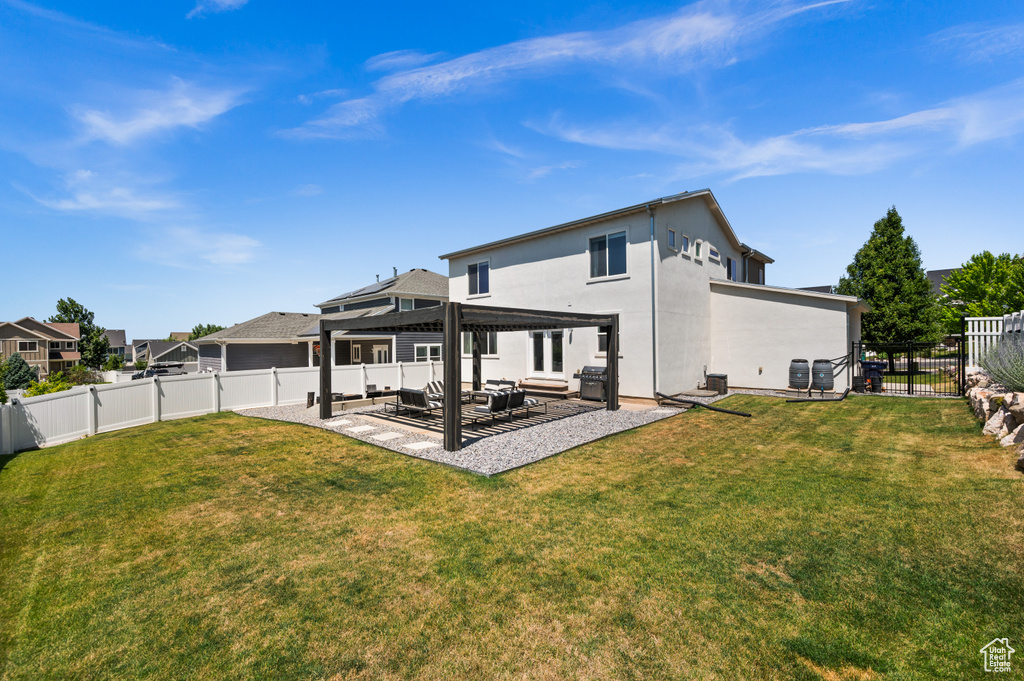 Back of property with a pergola, a fenced backyard, a patio area, stucco siding, and an outdoor hangout area