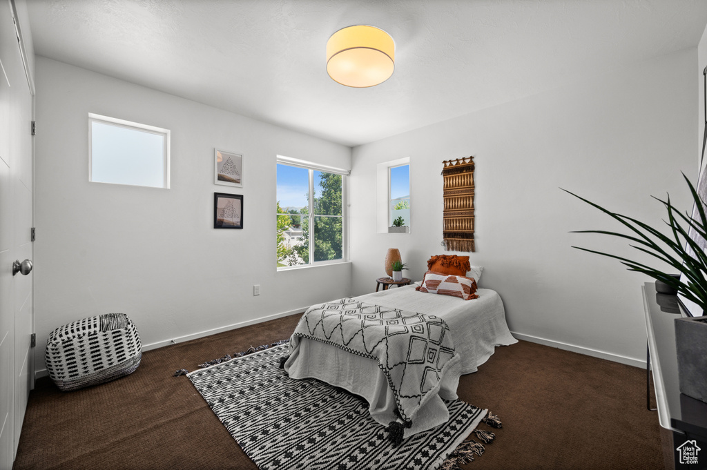Bedroom featuring carpet floors and baseboards