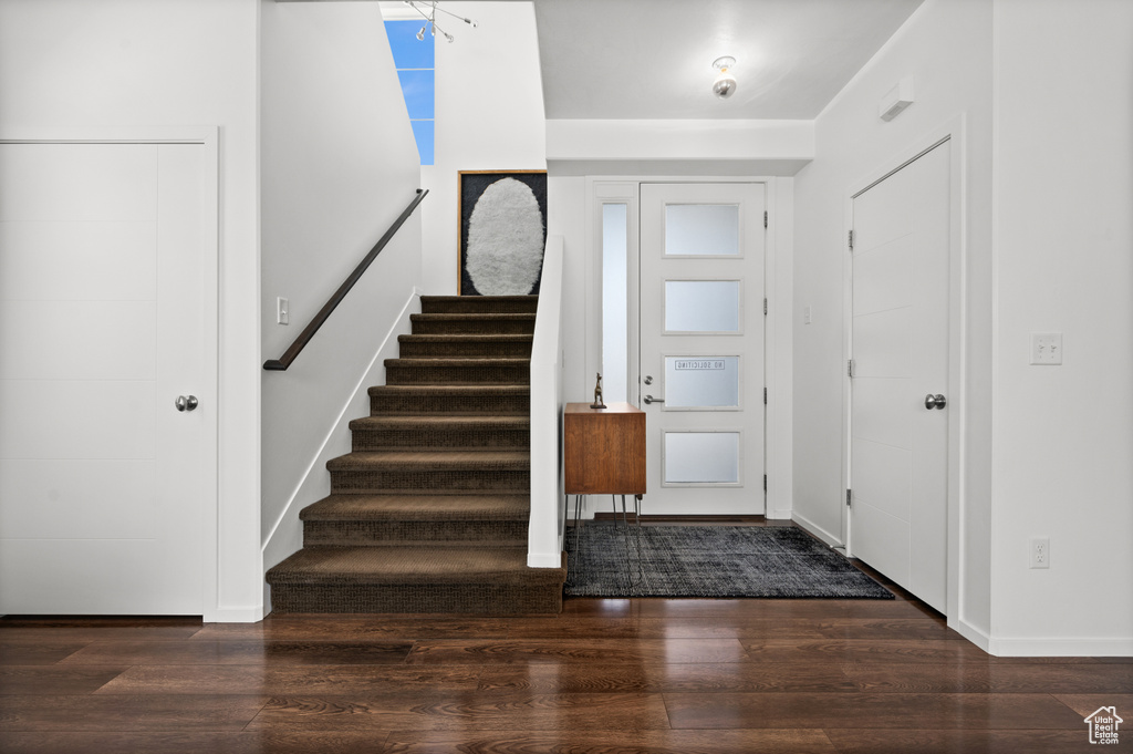 Foyer featuring wood finished floors and stairs