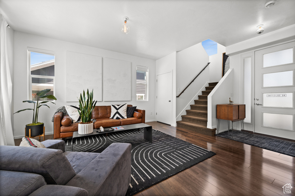 Living room featuring stairs and wood finished floors